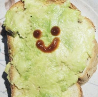 a slice of toast with a smiley face drawn on it